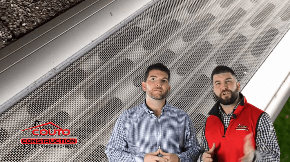 2 workers from Couto Construction in front of a backdrop of a gutter guard