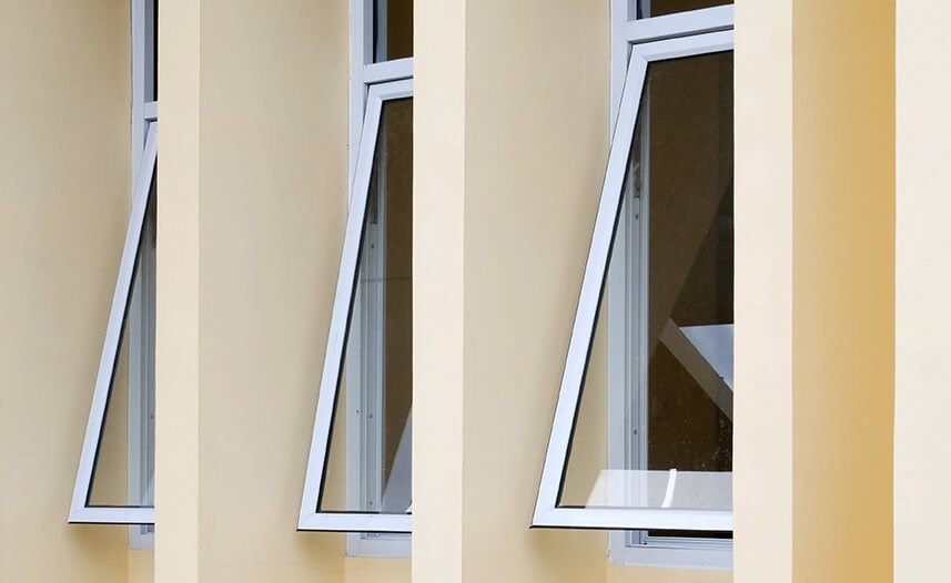 Multiple white hopper windows open on home exterior